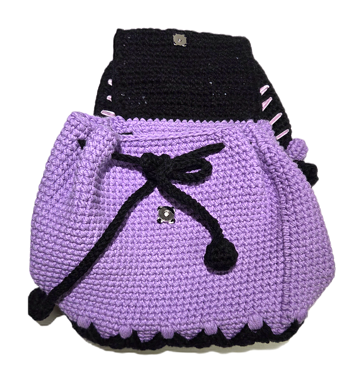 Crochet mini backpack with flap open showing magnetic snap and drawstring