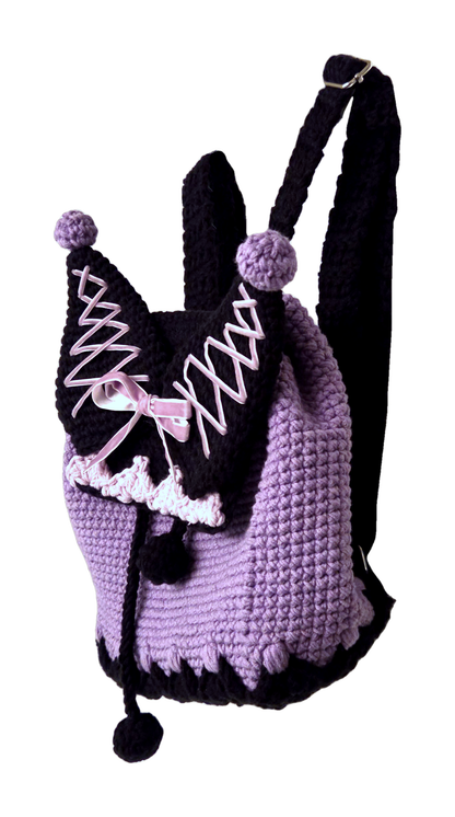 Crochet mini backpack angled side view showing adjustable black strap