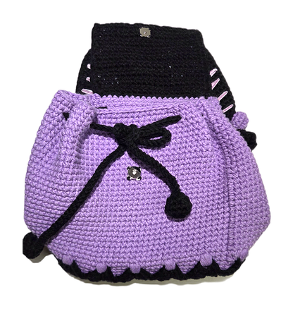 Crochet mini backpack with flap open showing magnetic snap and drawstring